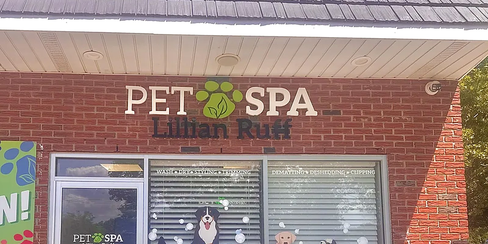 A packed tote for a dog's boarding stay outside the Lillian Ruff Pet Spa boarding entrance at 835 Portion Rd, Ronkonkoma